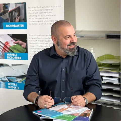 Sergio Nobile, Geschäftsführer der Edubook AG, sitzt an einem Tisch für ein Interview